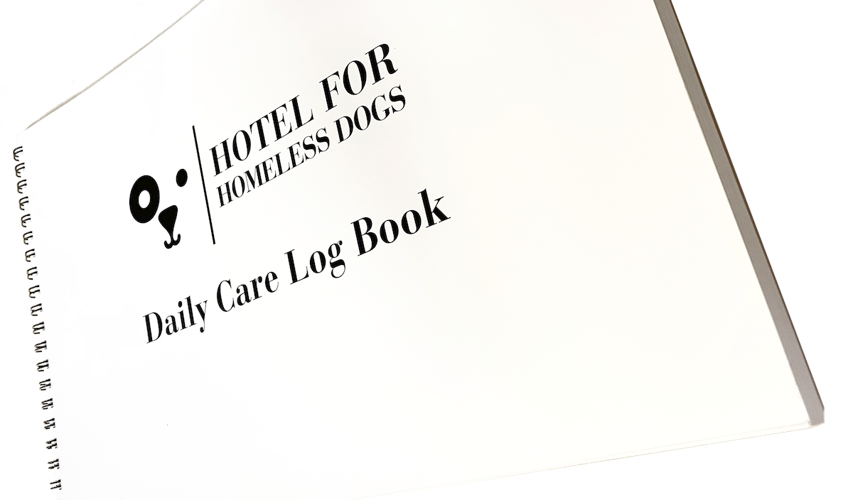 A Log Book with the text "Hotel for Homeless Dogs". A daily care log book.