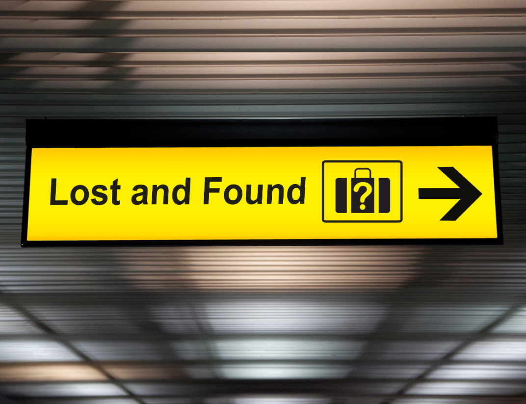 A bright yellow "Lost and Found" sign with an icon of a suitcase and an arrow pointing right.