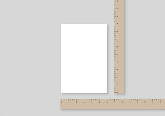 us trade sized paper with a ruler beside it